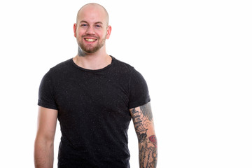 Studio shot of young bald muscular man