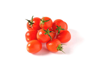 red cherry tomatoes with water drops on white background, isolate, close-up