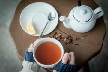 Cup of tea in womans hands close up