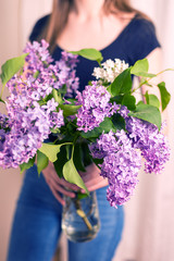 Woman holding lilac bouquet