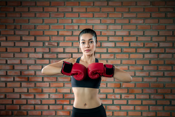 Asian sport woman wear boxing glove  in the gym,Thailand people workout,The best of fighther,Strong woman