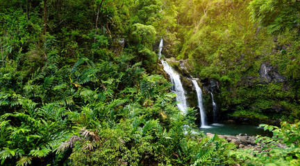 Upper Waikani Falls also known as Three Bears, a trio of large waterfalls amid rocks & lush...