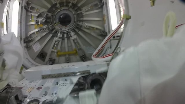 POV close up, astronaut works on International Space Station