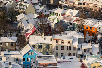 Fototapeta premium Aerial view of traditional urban developement in Reykjavik, Iceland in winter with snow covered roofs viewed from above.