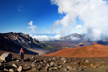 Tourist hiking in Haleakala volcano crater on the Sliding Sands trail. Beautiful view of the crater floor and the cinder cones below. Maui, Hawaii © MNStudio