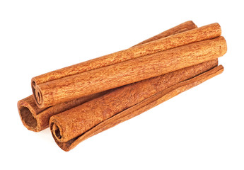 Three cinnamon sticks on a white background