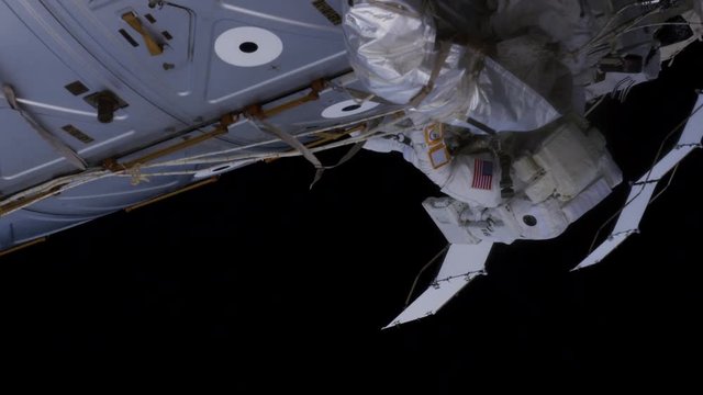 Zoom in, astronaut works on International Space Station