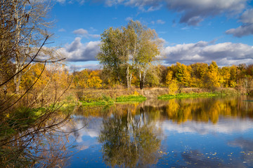 Beautiful autumn landscape - View from the river bank with reflection in water, the river Siverskyi Donets, north-east of Ukraine.