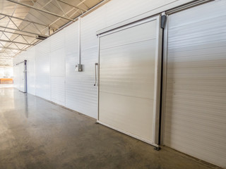 large freezer storage in the factory. closed door from warehouse