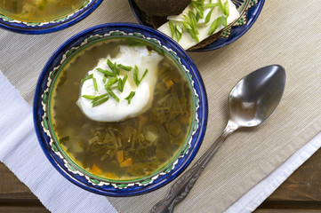 Diet sorrel soup with egg. on a wooden table.
