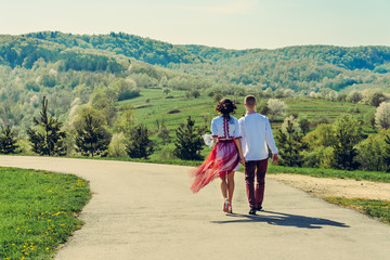 Fototapeta premium A young lovers couple goes back to the village on the Ukrainian way