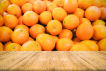 Empty top wooden table and blurred of tangerine orange background. For product display.