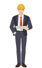 Businesswoman in construction helmet holding digital tablet PC