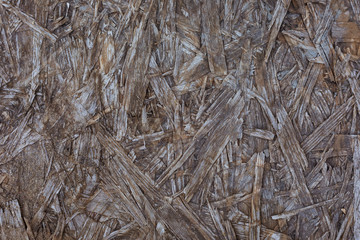 Old weathered chipboard texture close-up