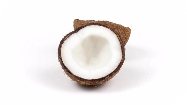 Two ripe tropical coconut halves with yummy white pulp rotating on white isolated background. Healthy fresh tropical fruits. Loopable seamless cocos rotating