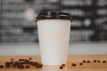 White paper cups of coffee with black caps presented in front grains lie on table. Food delivery concept - Powered by Adobe