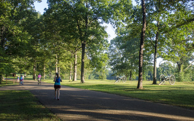 Joggers run near Civil War era cannon along Jackson's Line at the Fredericksburg Battlefield, Fredericksburg & Spotsylvania National Military Park, Fredericksburg, Vieginia.