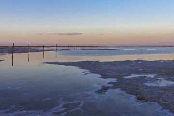 the shore of the salt lake Baskunchak in the summer evening. Astrakhan region, Russia.