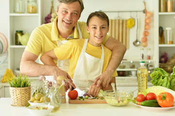 father and son cooking breakfast