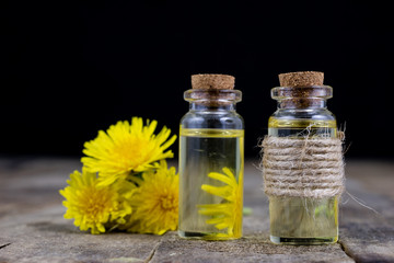 Syrup with dandelion on a wooden table. Cure for colds from natural ingredients.