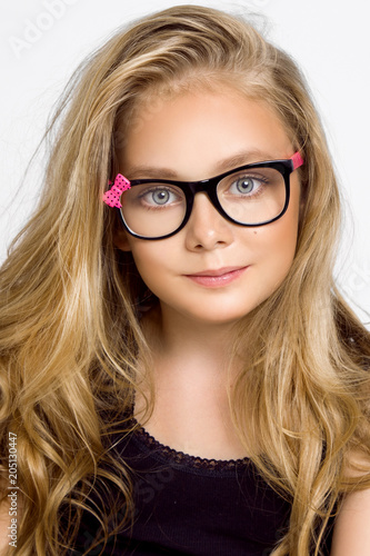Cute Blonde Little Girl In Glasses On A White Background In The