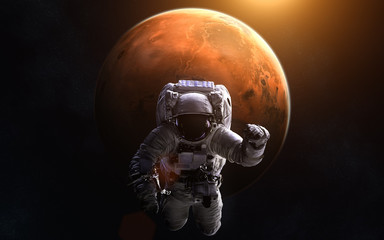 Astronaut on background of Mars. Image in 5K resolution for desktop wallpaper. Elements of the image are furnished by NASA