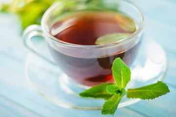 tea in a glass cup and fresh mint leaves