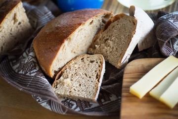 Bread and cheese on wooden board.