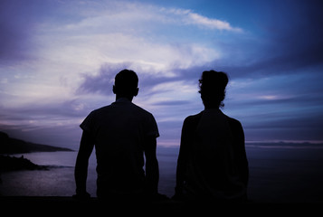 Young couple's silhouette and a storm landscape