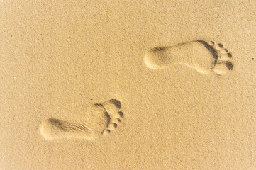 Fototapeta na wymiar Two Footprints in sand at the Beach