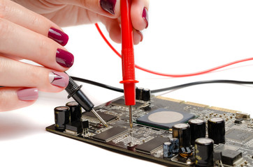 Beautiful female hands test the computer board