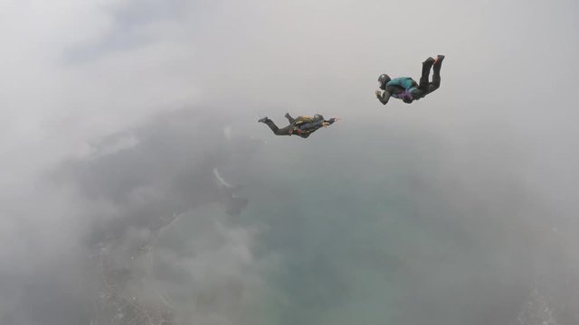 Skydivers having fun above the clouds