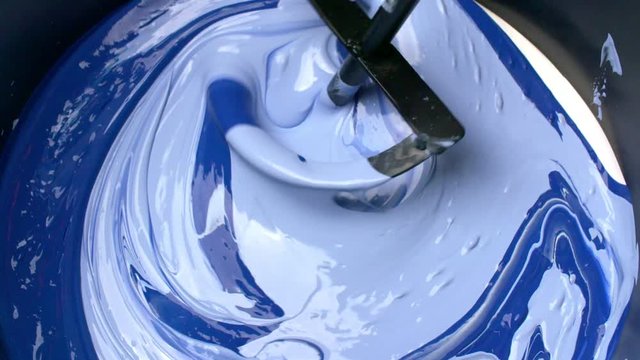 Inside the mixer are mixing liquids of different colors