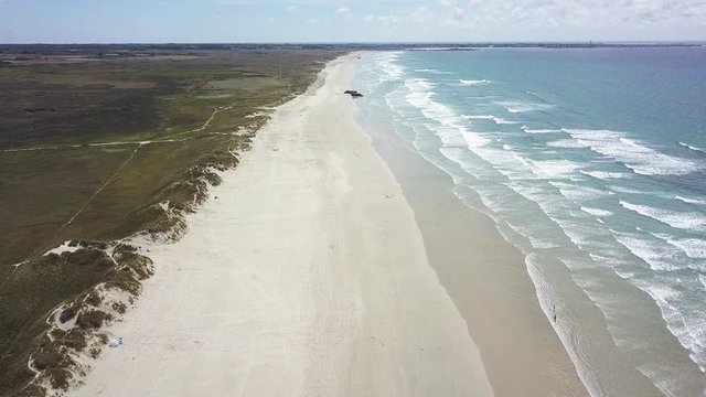 Wide aerial, empty beach in France