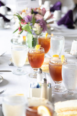 Table setting with flowers tea lemon water white linens
