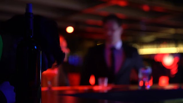 Happy couple at nightclub, drunk man falling on bar counter, breakup depression