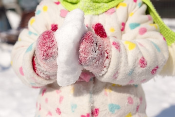 Child holding a snowball