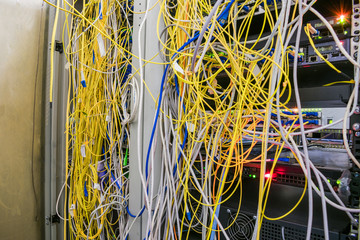 Entangled Internet wires are in the server room. Disorderly connection of optical cables with...