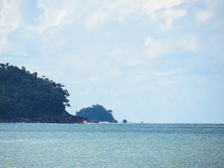 Close view of islands and cliffs in the blue-green sea and blue sky.