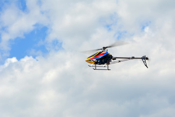 Homemade radio control helicopter on blue sky.