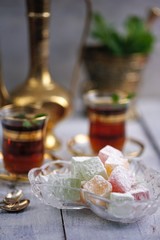 traditional oriental dessert Turkish Delight on an old table  with mint tea