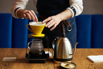 Bartender Hand drip coffee , Barista pouring water on coffee ground with paper filter
