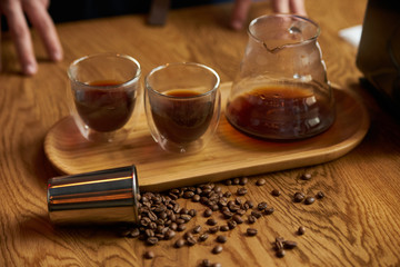 Barista prepare coffee at bar counter using different glassware and utensil, close-up