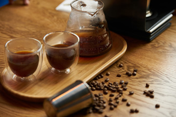 Barista prepare coffee at bar counter using different glassware and utensil, close-up