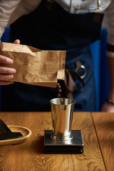 Fototapeta na wymiar Barista prepare coffee at bar counter using different glassware and utensil, close-up