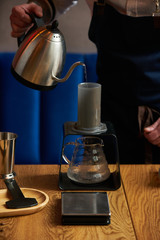 Obraz na płótnie Canvas Barista prepare coffee at bar counter using different glassware and utensil, close-up