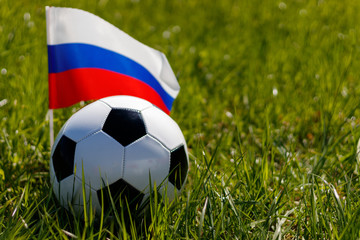 Fototapeta premium Soccer ball on the grass and the Russian flag. There is a place for the inscription