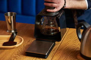 Professional barista preparing coffee alternative method, close-up