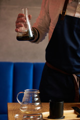 Professional barista preparing coffee alternative method, close-up