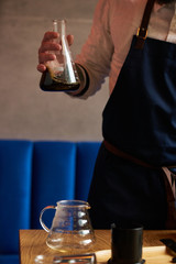 Professional barista preparing coffee alternative method, close-up